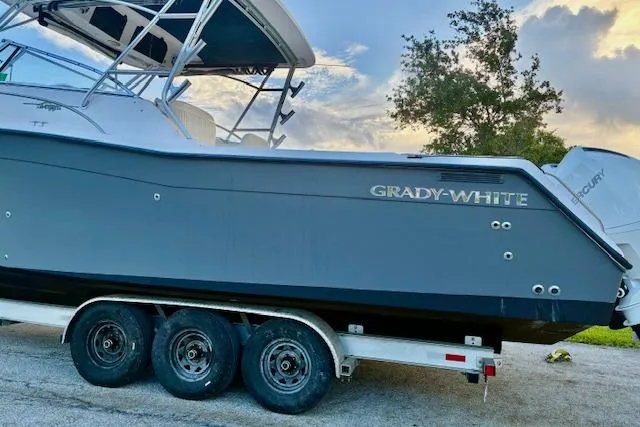 Slide: The Image of 2003 Grady-White Express 330 boat on trailer, parked outdoors. - 4