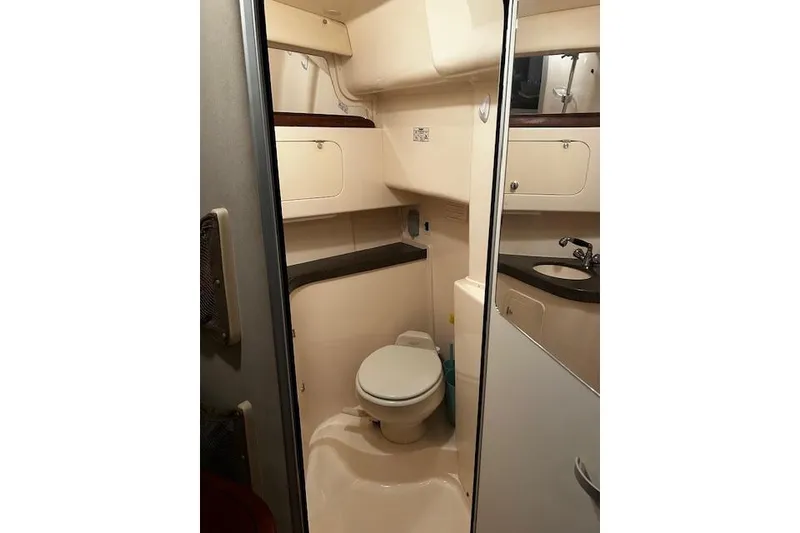 Slide: The Image of 2003 Grady-White Express 330 boat bathroom interior with toilet and sink. - 42