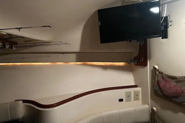 Slide: The Image of Interior of 2003 Grady-White Express 330 boat with TV and seating area. - 43