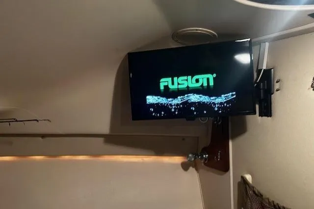 Slide: The Image of Interior of 2003 Grady-White Express 330 with mounted Fusion TV screen. - 44