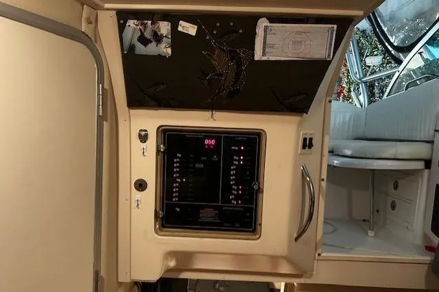 Slide: The Image of 2003 Grady-White Express 330 cabin interior with control panel and seating area. - 48