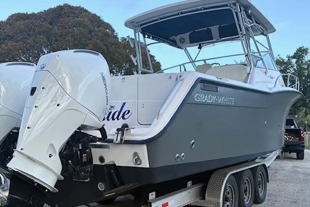 Slide: The Image of 2003 Grady-White Express 330 boat on trailer, featuring twin Mercury outboard engines. - 5