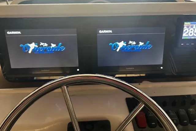 Slide: The Image of Dashboard of a 2003 Grady-White Express 330 boat with Garmin displays. - 9