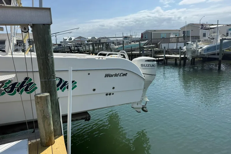 Slide: The Image of 2005 World Cat 330 TE boat docked with Suzuki outboard motor. - 10