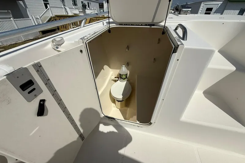 Slide: The Image of 2005 World Cat 330 TE boat with open compartment showing a marine toilet. - 14