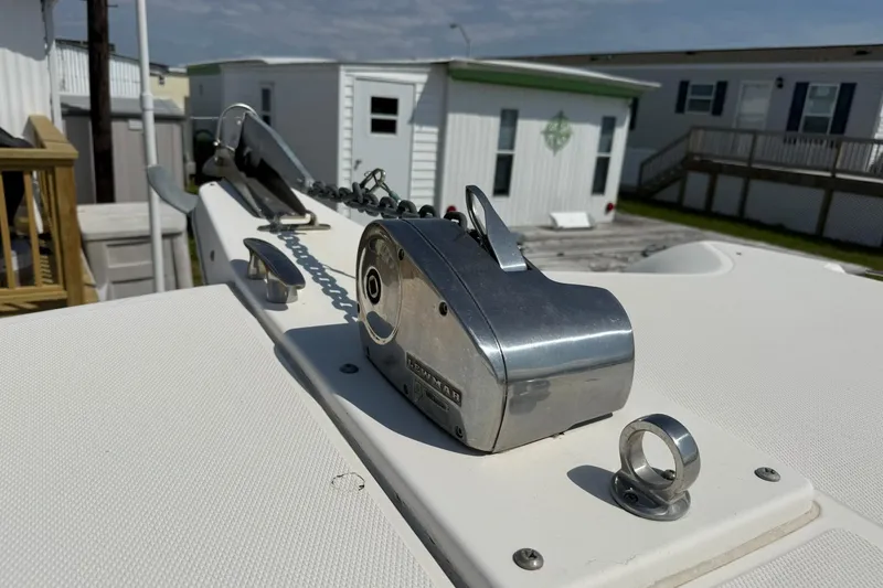 Slide: The Image of 2005 World Cat 330 TE boat anchor system with chain, docked near mobile homes. - 16
