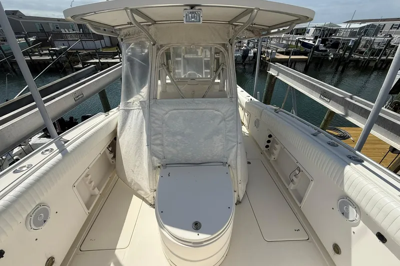 Slide: The Image of 2005 World Cat 330 TE boat interior with seating and canopy, docked at marina. - 18