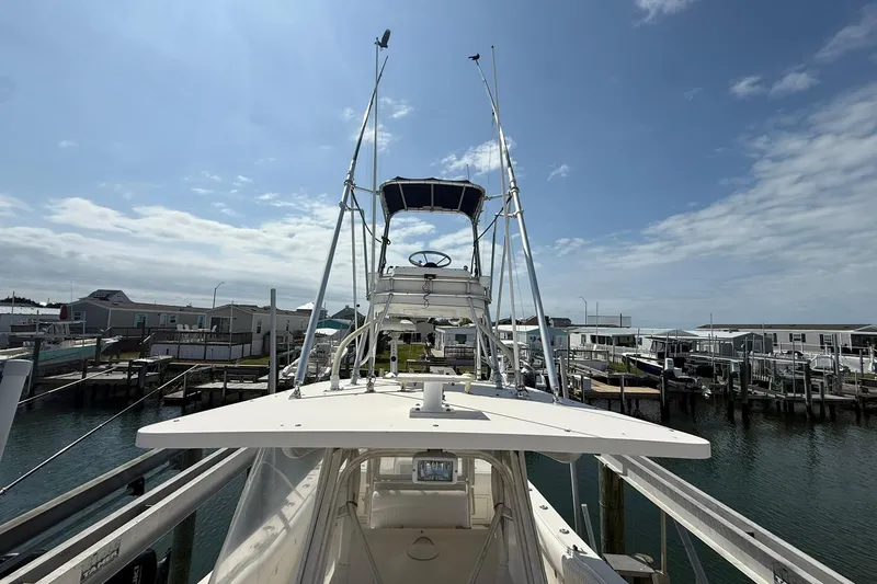Slide: The Image of 2005 World Cat 330 TE boat docked at marina under clear blue sky. - 19
