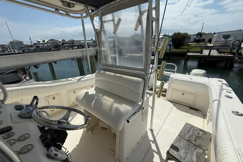 Slide: The Image of 2005 World Cat 330 TE boat interior with helm, seating, and waterfront view. - 20