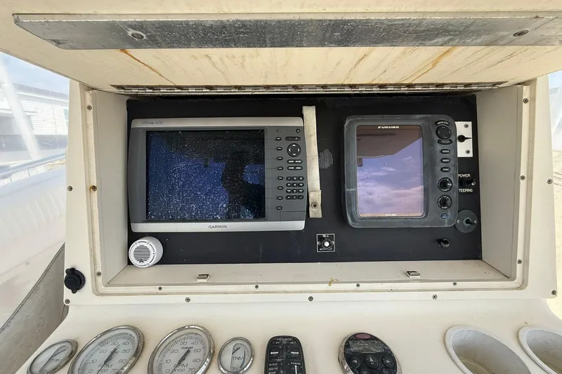Slide: The Image of 2005 World Cat 330 TE boat dashboard with Garmin and Furuno navigation systems. - 22