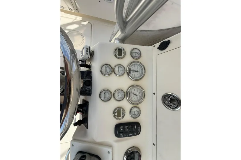 Slide: The Image of Dashboard of a 2005 World Cat 330 TE boat with gauges and controls. - 23
