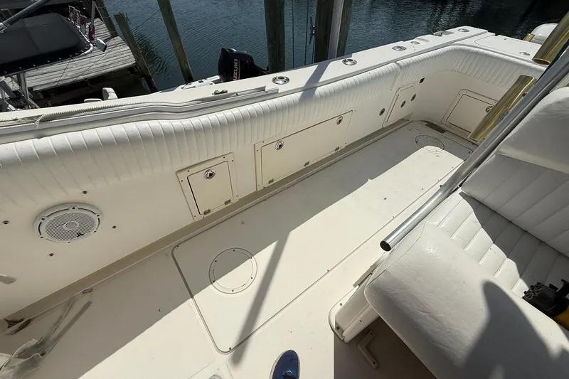 Slide: The Image of 2005 World Cat 330 TE boat interior with white seating and storage compartments. - 24