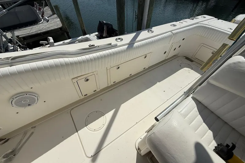 Slide: The Image of 2005 World Cat 330 TE boat interior with white seating and storage compartments. - 25