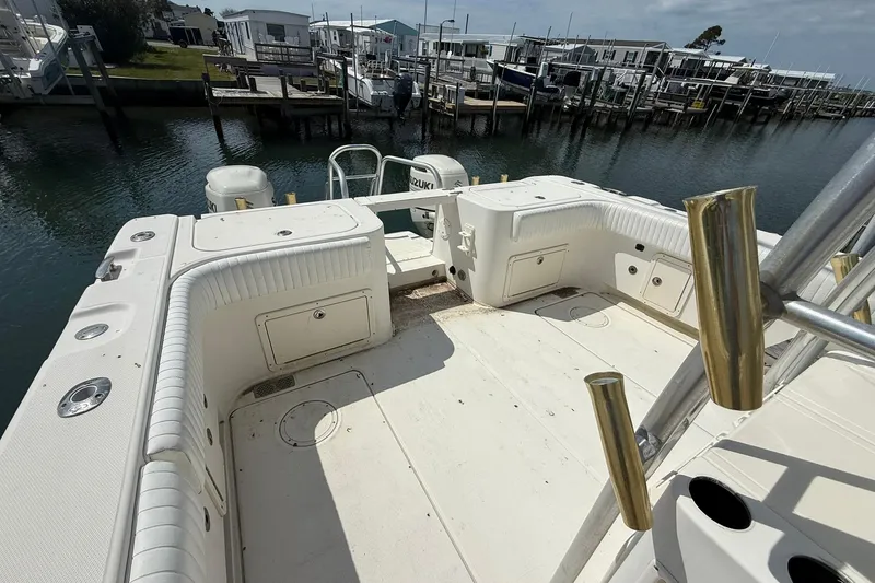 Slide: The Image of 2005 World Cat 330 TE boat deck with fishing rod holders, docked at marina. - 26
