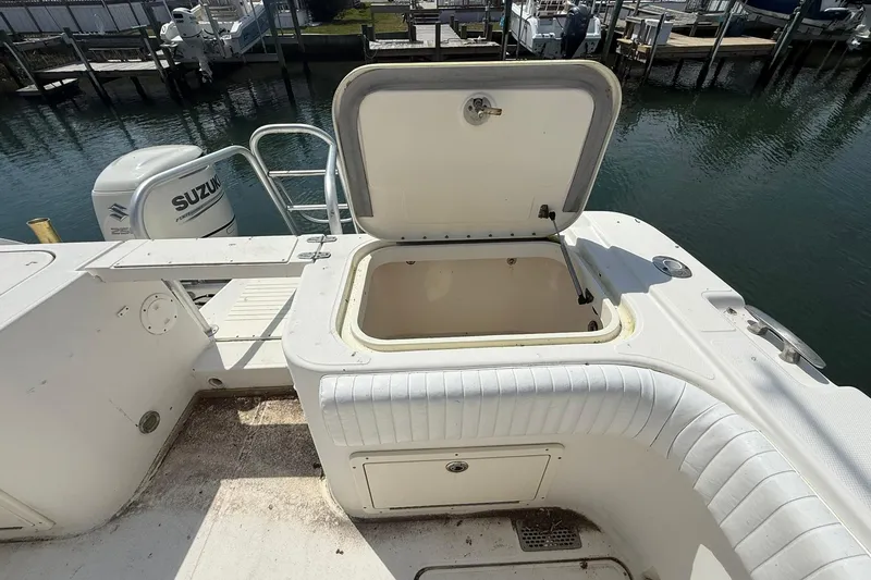Slide: The Image of 2005 World Cat 330 TE boat with open storage compartment and Suzuki engine. - 34
