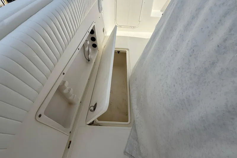 Slide: The Image of Interior view of a 2005 World Cat 330 TE boat, featuring storage compartments. - 35