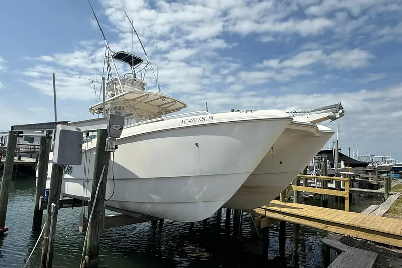 Slide: The Image of 2005 World Cat 330 TE boat docked under a cloudy sky. - 36