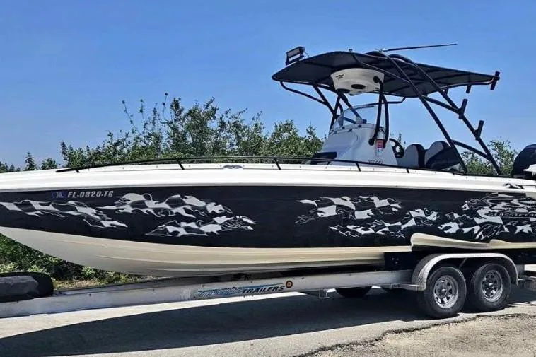 The Image of 2011 Glasstream 280 SCX boat on trailer with custom graphics and T-top. - 1