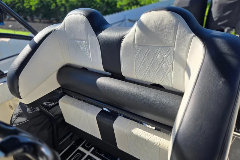 Slide: The Image of 2011 Glasstream 280 SCX boat seat with black and white diamond-patterned upholstery. - 13