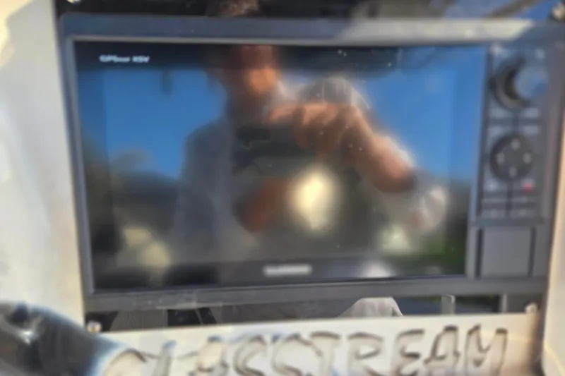 Slide: The Image of Close-up of a 2011 Glasstream 280 SCX dashboard with a GPS display. - 14