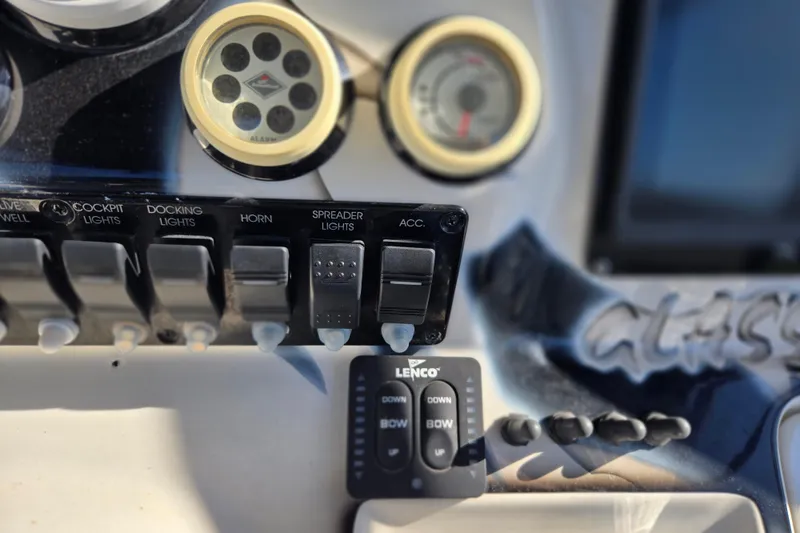 Slide: The Image of Control panel of a 2011 Glasstream 280 SCX boat with switches and gauges. - 15