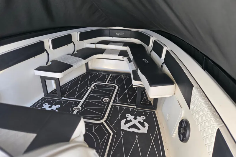 Slide: The Image of Interior of 2011 Glasstream 280 SCX boat with black and white seating and nautical-themed flooring. - 19