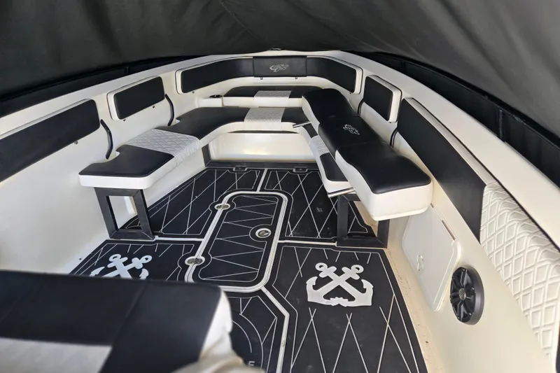 Slide: The Image of Interior of 2011 Glasstream 280 SCX boat with black and white seating and nautical-themed flooring. - 20
