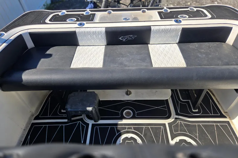 Slide: The Image of 2011 Glasstream 280 SCX boat interior with black and white seating and patterned flooring. - 22