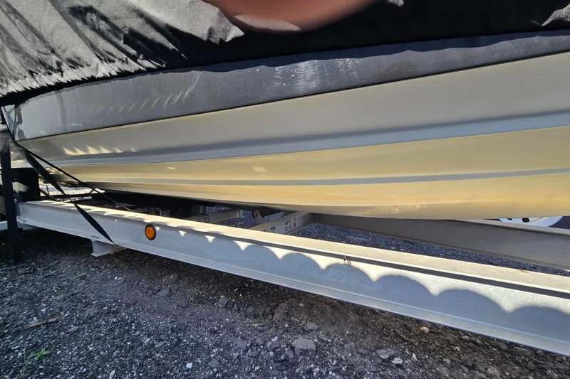 Slide: The Image of 2011 Glasstream 280 SCX boat on trailer, partially covered, side view. - 26