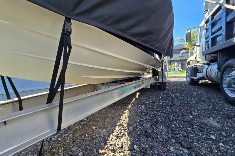 Slide: The Image of 2011 Glasstream 280 SCX boat on trailer, covered, parked beside a truck. - 27