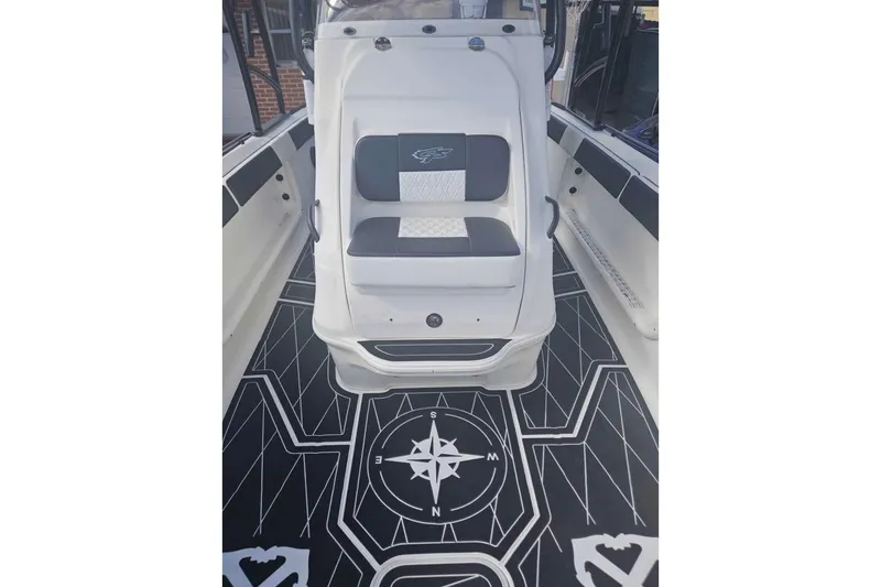 Slide: The Image of 2011 Glasstream 280 SCX boat interior with compass-themed flooring design. - 5