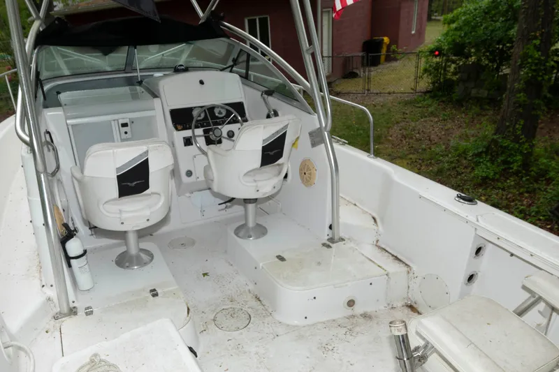 Slide: The Image of 1999 Pro-Line 241 Walkaround boat interior with helm, seats, and steering wheel. - 5