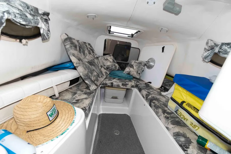Slide: The Image of 1999 Pro-Line 241 Walkaround cabin interior with patterned cushions and storage compartments. - 6