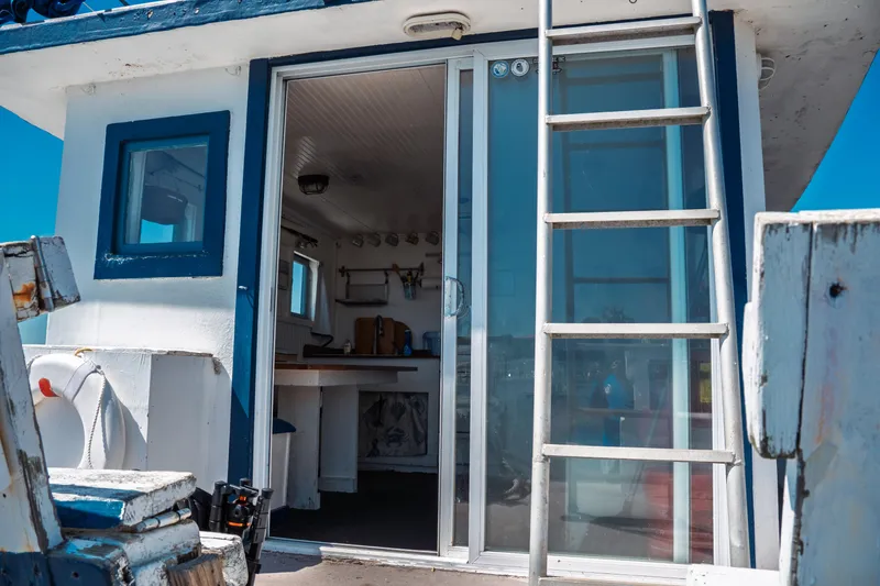 Slide: The Image of 1977 Saint Augustine 43 Trawler cabin with ladder and sliding door, nautical interior view. - 10