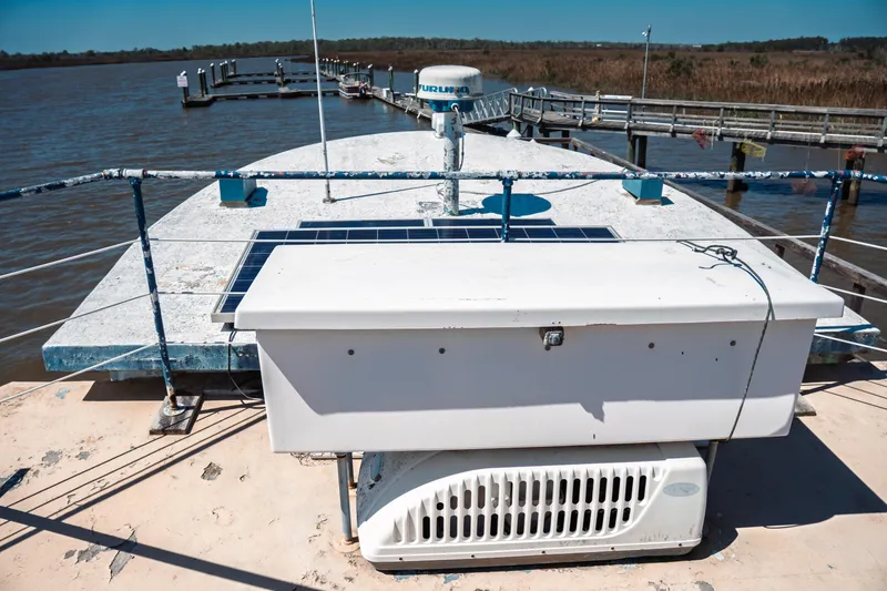 Slide: The Image of 1977 Saint Augustine 43 Trawler on water, featuring deck equipment and solar panels. - 16