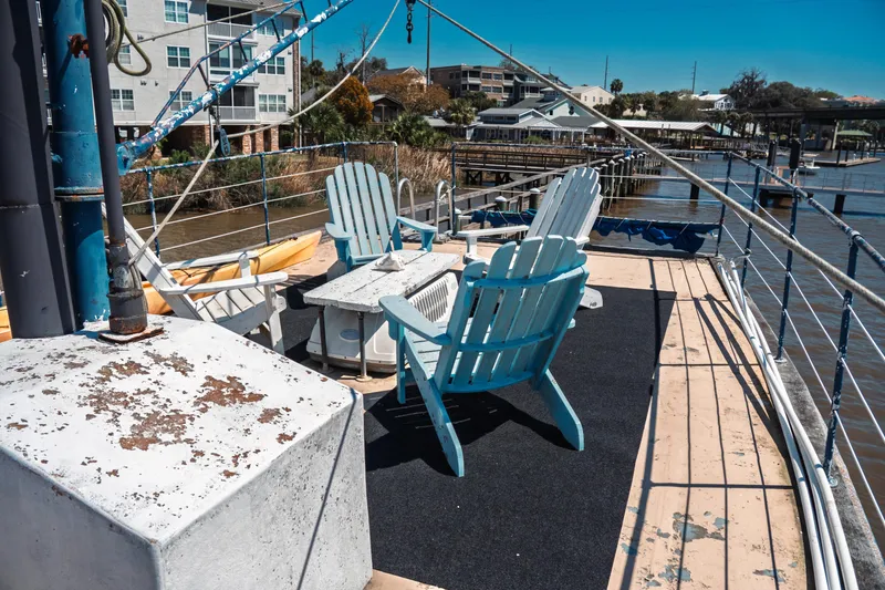 Slide: The Image of Deck of 1977 Saint Augustine 43 Trawler with blue chairs and waterfront view. - 18