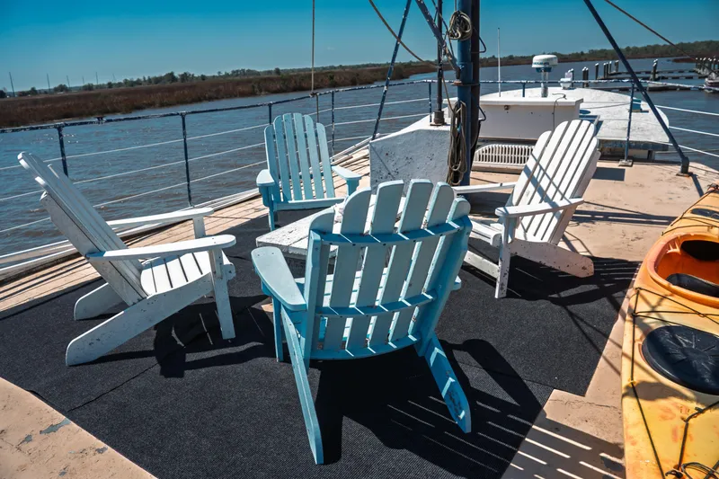 Slide: The Image of Deck of 1977 Saint Augustine 43 Trawler with Adirondack chairs and kayak. - 22