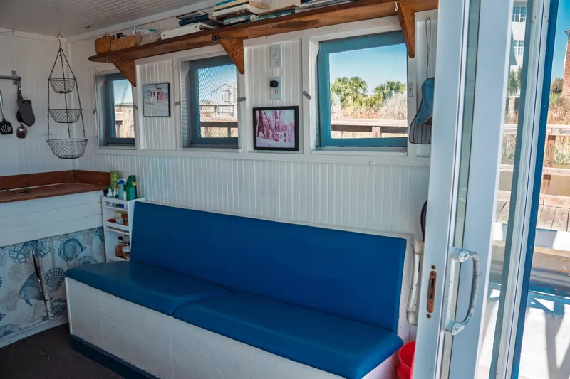 Slide: The Image of Interior of 1977 Saint Augustine 43 Trawler with blue seating and nautical decor. - 25