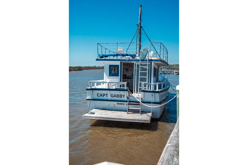 Slide: The Image of 1977 Saint Augustine Trawler 43 docked on a sunny day, named "Capt Gabby." - 3