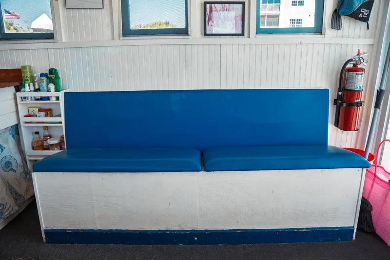 Slide: The Image of Blue cushioned bench on 1977 Saint Augustine Trawler 43, with fire extinguisher nearby. - 34