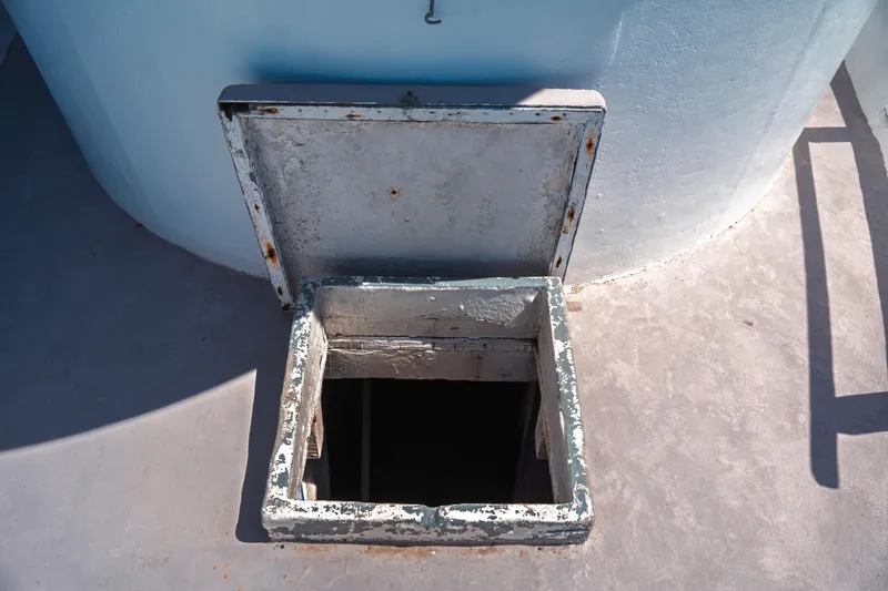 Slide: The Image of Open hatch on 1977 Saint Augustine 43 Trawler deck, showing weathered metal frame. - 37