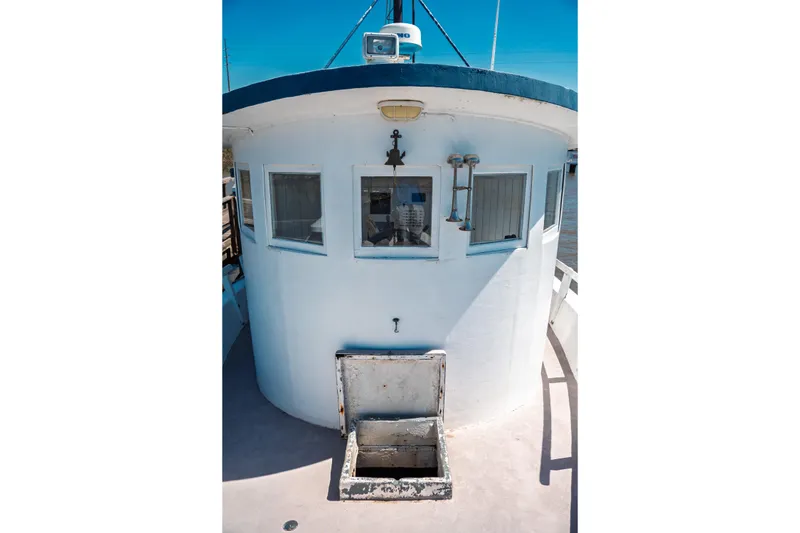 Slide: The Image of 1977 Saint Augustine 43 Trawler with white cabin and open hatch on deck. - 38