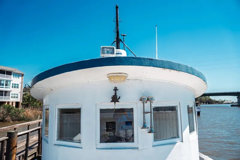 Slide: The Image of 1977 Saint Augustine 43 Trawler docked by the river under a clear blue sky. - 40