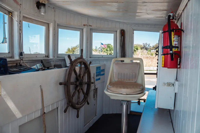 Slide: The Image of 1977 Saint Augustine Trawler 43 interior with helm, captain's chair, and fire extinguisher. - 41