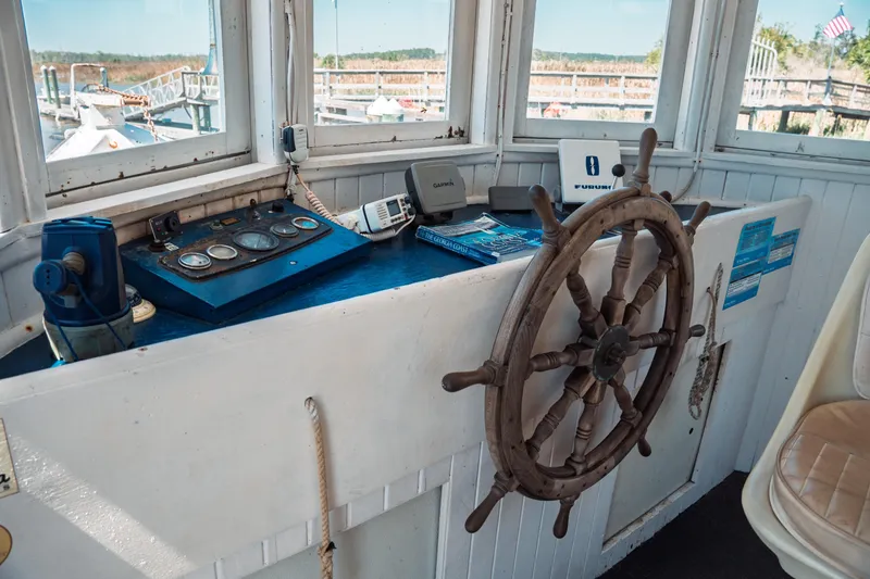 Slide: The Image of 1977 Saint Augustine Trawler 43 helm with vintage wooden wheel and navigation instruments. - 42