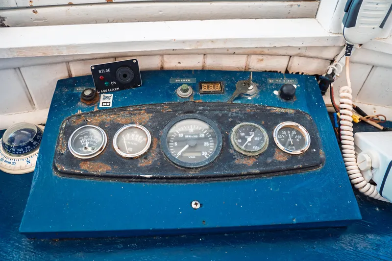 Slide: The Image of Control panel of a 1977 Saint Augustine 43 Trawler with gauges and switches. - 43