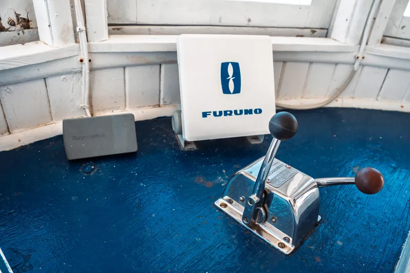 Slide: The Image of 1977 Saint Augustine Trawler 43 cockpit with Furuno and Raymarine navigation equipment. - 45