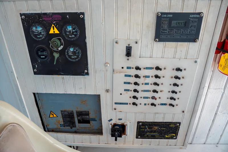 Slide: The Image of Control panel of a 1977 Saint Augustine 43 Trawler with gauges and switches. - 46
