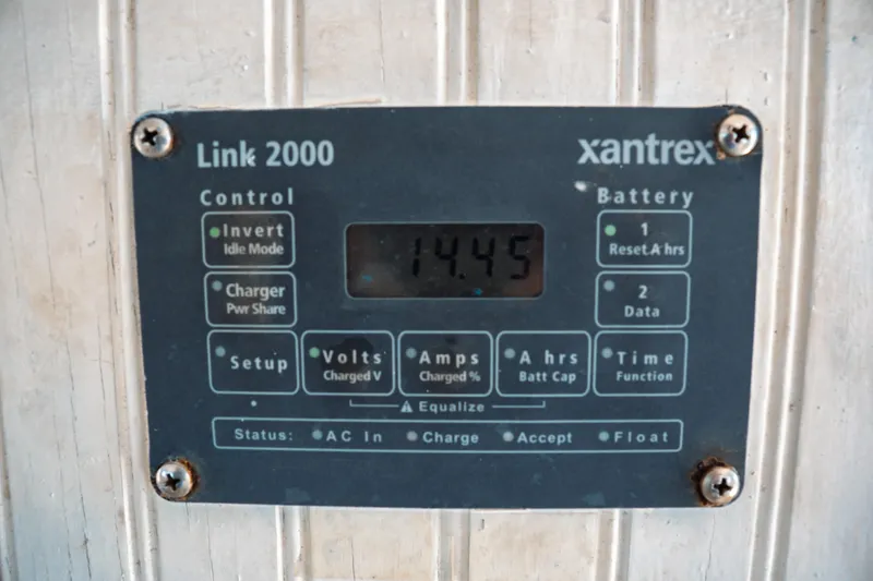 Slide: The Image of Xantrex Link 2000 control panel displaying 14.45 volts on a 1977 Saint Augustine Trawler. - 47