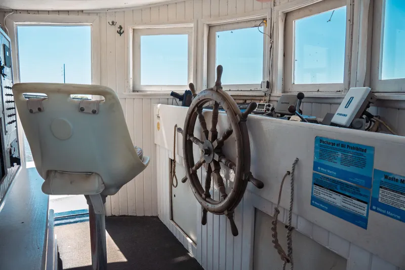 Slide: The Image of 1977 Saint Augustine Trawler 43 interior with helm, captain's chair, and navigational equipment. - 50